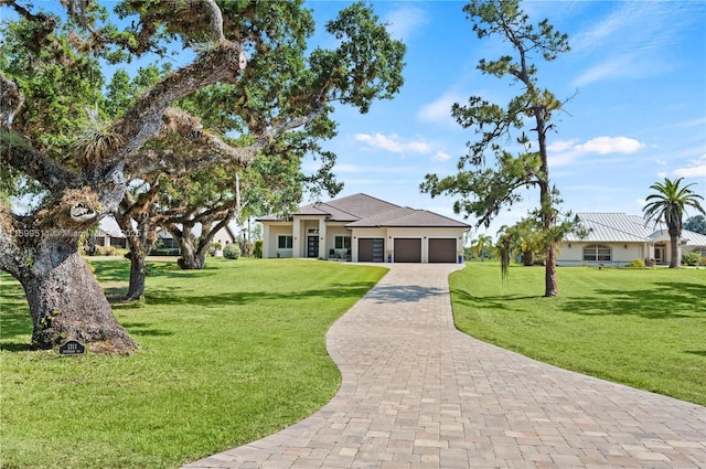 view of front of home with a garage and a front yard