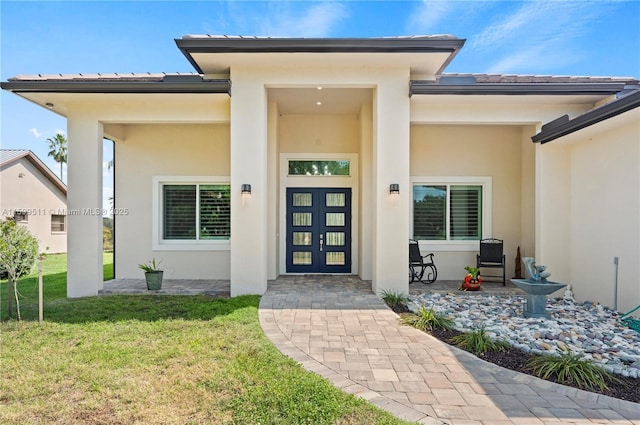 property entrance with a yard