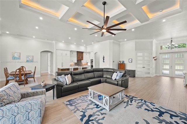 living room with beamed ceiling, coffered ceiling, and light wood-type flooring