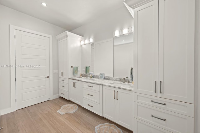 bathroom with vanity and hardwood / wood-style floors