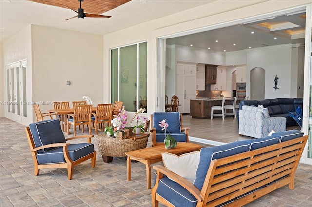 view of patio / terrace with outdoor lounge area, sink, and ceiling fan