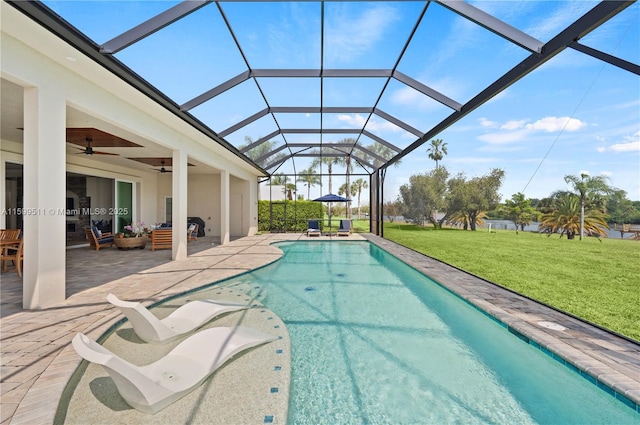 view of pool featuring a patio, a lanai, a yard, and ceiling fan