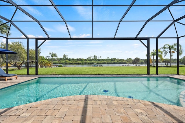 view of swimming pool featuring a water view, a yard, a patio area, and a lanai