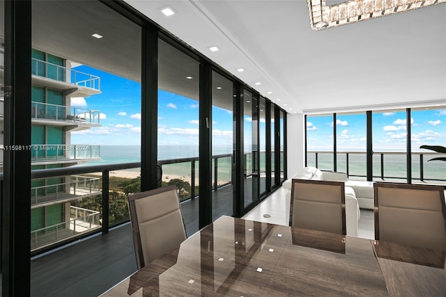 dining room with floor to ceiling windows and a water view