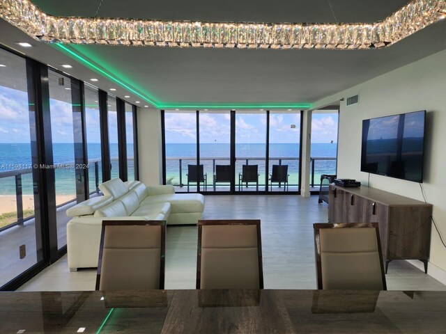 9455 Collins Ave Unit 809, Surfside, FL 33154 - living room featuring a healthy amount of sunlight, a water view, and floor to ceiling windows
