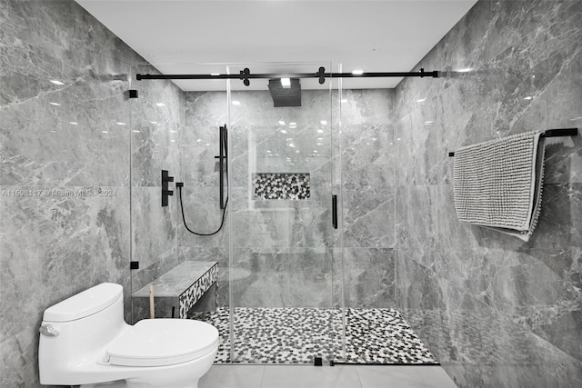 bathroom featuring a shower with shower door, tile flooring, tile walls, and toilet