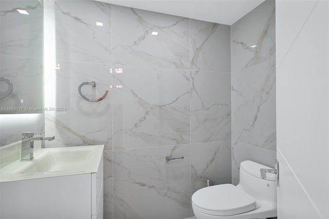 9455 Collins Ave Unit 809, Surfside, FL 33154 - bathroom with tile walls, vanity, and toilet