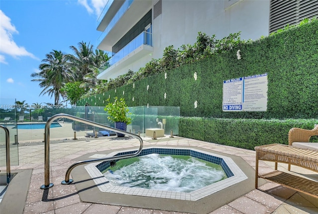 view of pool featuring a patio area and a community hot tub