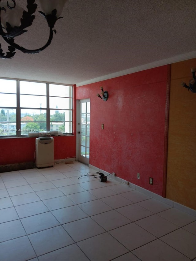 tiled spare room with a textured ceiling