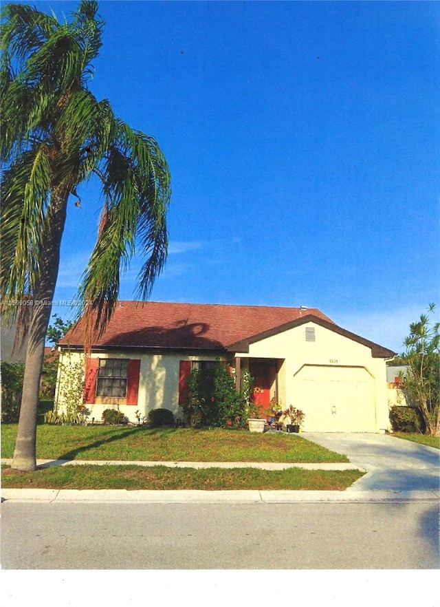 view of front of house with a front lawn and a garage