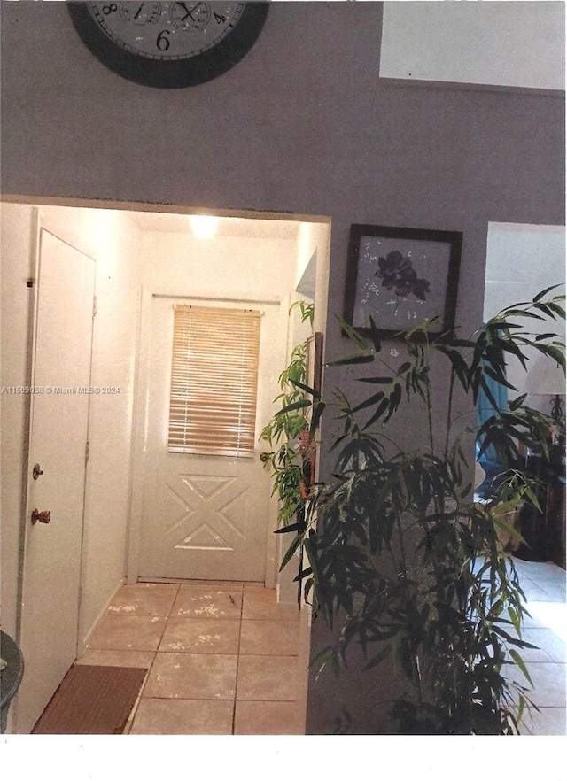 doorway to outside featuring light tile patterned floors