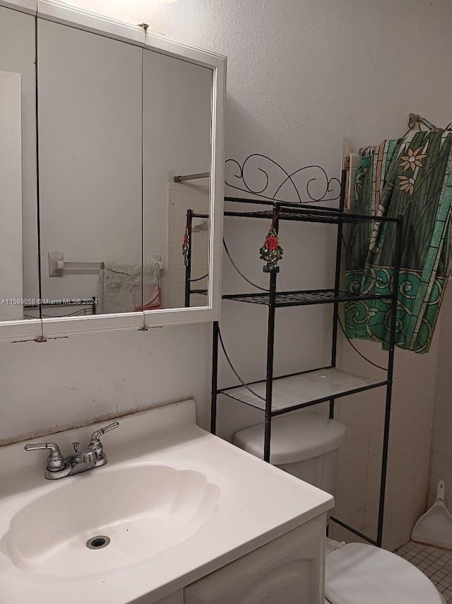 bathroom with vanity, toilet, and tile patterned floors