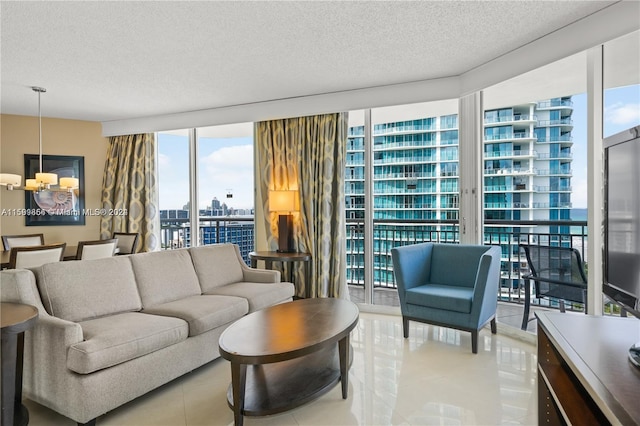 living room with floor to ceiling windows, a notable chandelier, a city view, light tile patterned floors, and a textured ceiling