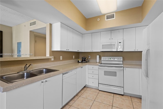 kitchen with light tile patterned floors, white appliances, a sink, and visible vents