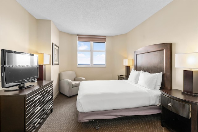 bedroom with a textured ceiling and carpet flooring