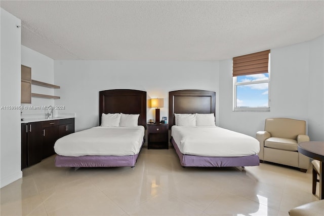 bedroom featuring a textured ceiling and light tile patterned floors