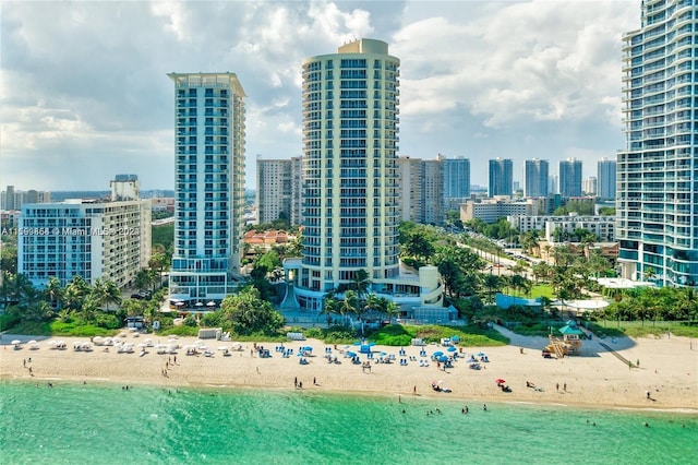 view of city featuring a water view and a beach view