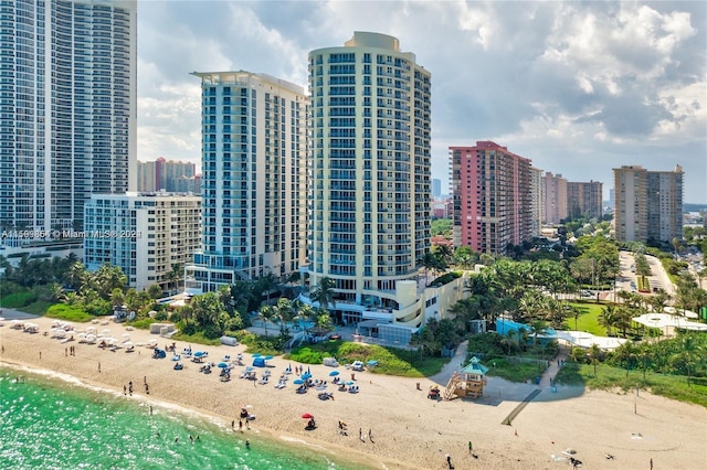 exterior space with a water view and a beach view