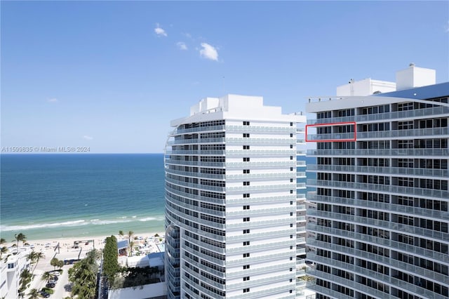 view of property featuring a beach view and a water view