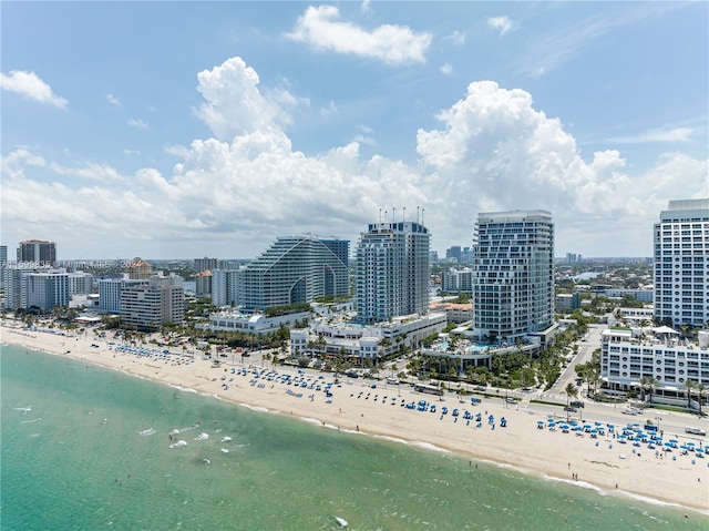 drone / aerial view featuring a beach view and a water view