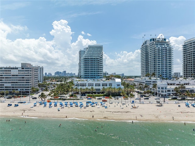 birds eye view of property with a beach view and a water view