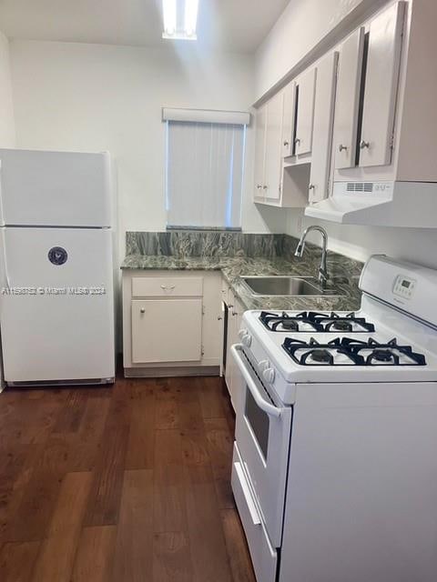 kitchen featuring dark wood-type flooring, sink, white appliances, and white cabinetry