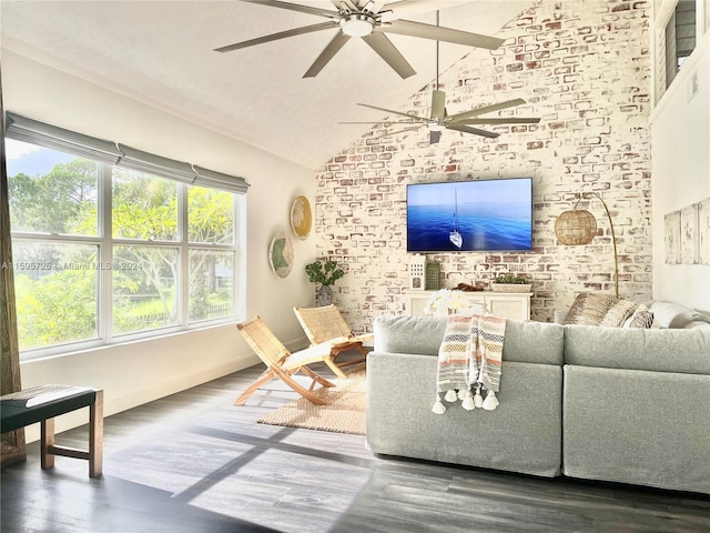 living room featuring dark hardwood / wood-style floors, high vaulted ceiling, ceiling fan, and brick wall