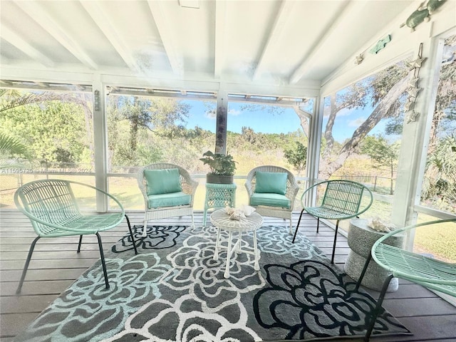 sunroom with beamed ceiling and a wealth of natural light