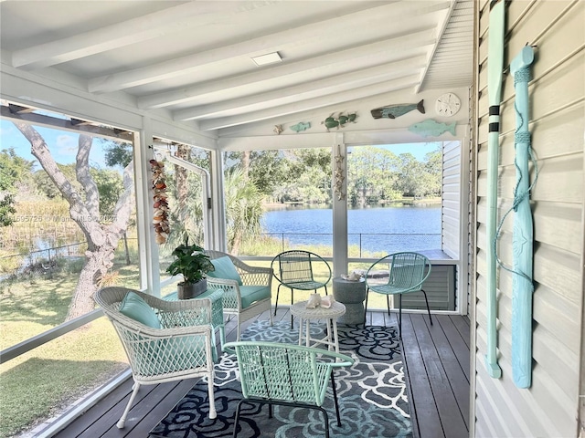 sunroom with vaulted ceiling with beams and a water view