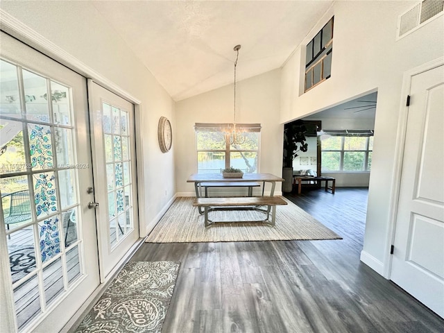 interior space with dark hardwood / wood-style floors, high vaulted ceiling, french doors, and a chandelier