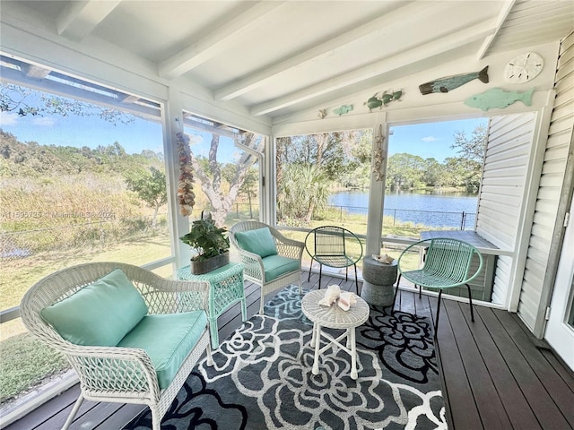 sunroom featuring vaulted ceiling with beams and a water view