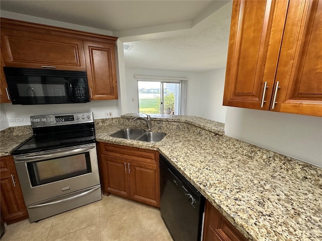 kitchen featuring light tile patterned flooring, sink, black appliances, light stone countertops, and a textured ceiling