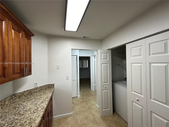 interior space with washer / dryer and stone counters