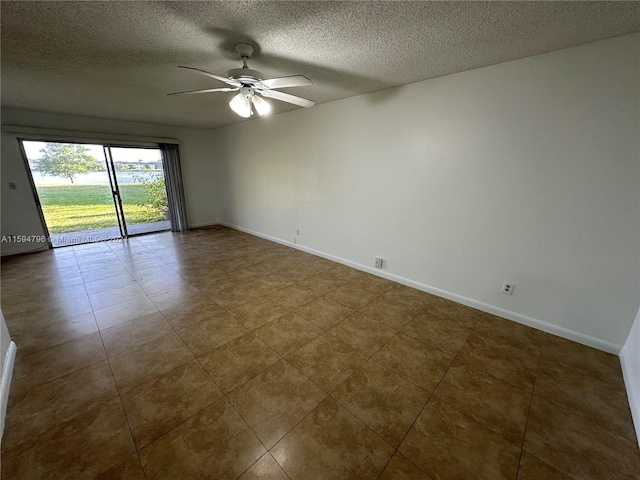 spare room with ceiling fan and a textured ceiling