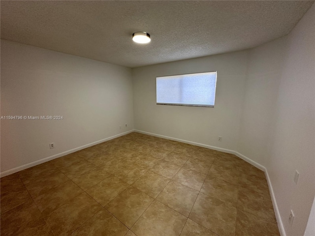 empty room with a textured ceiling