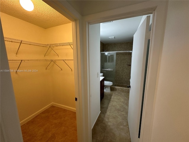 spacious closet featuring tile patterned flooring