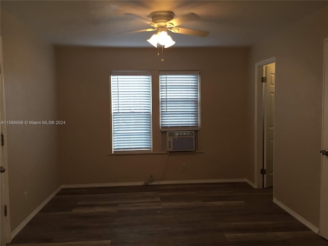 spare room featuring dark hardwood / wood-style floors, cooling unit, and ceiling fan