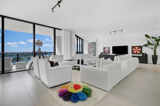 living room with expansive windows, light tile flooring, and track lighting