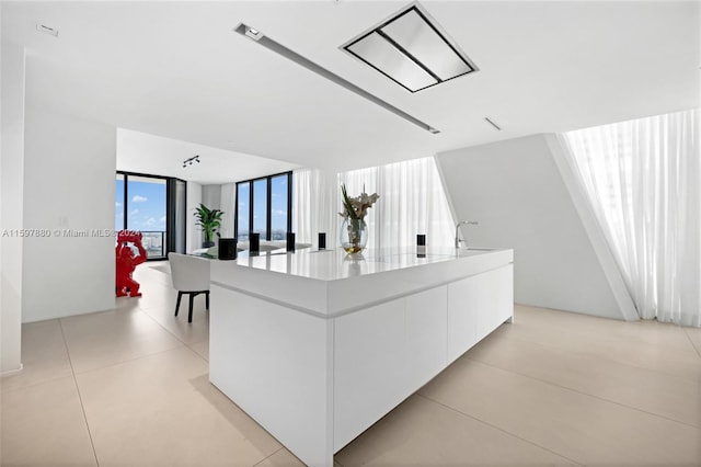 hallway featuring sink and light tile floors