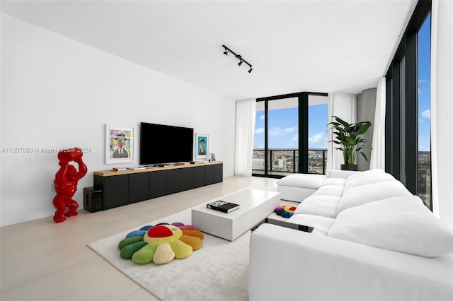 tiled living room featuring floor to ceiling windows and track lighting