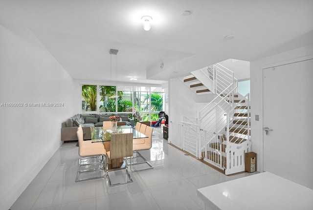 living room with a wall of windows and light tile patterned floors