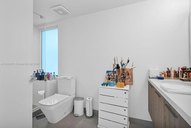 bathroom with tile patterned floors, vanity, and toilet