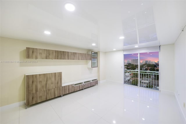 unfurnished room with baseboards, recessed lighting, and light tile patterned floors