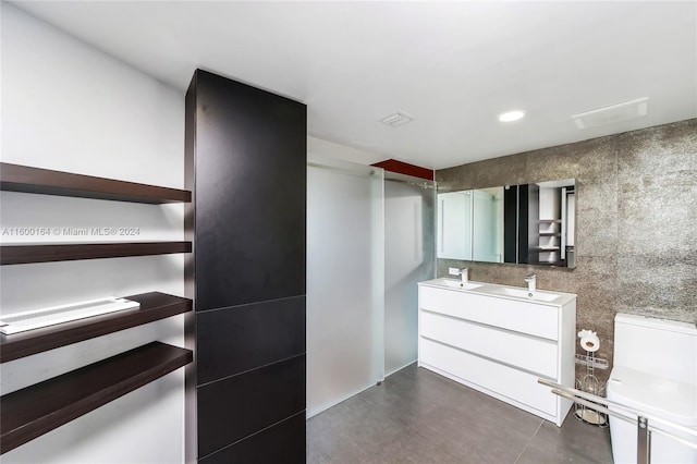 walk in closet with sink and dark tile patterned flooring