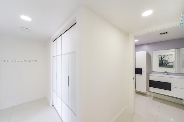 hall featuring light tile patterned floors