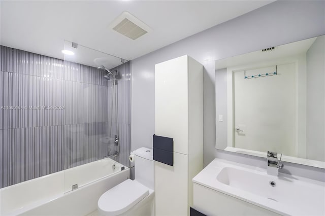 bathroom featuring toilet,  shower combination, and vanity