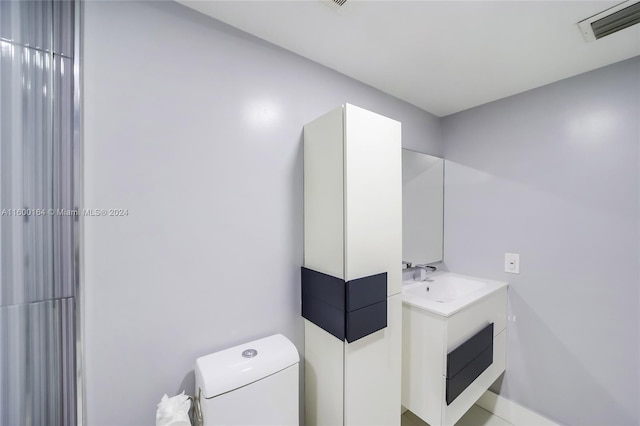 bathroom with toilet and vanity