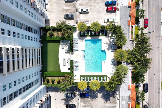 aerial view of a pool area and apartment complex