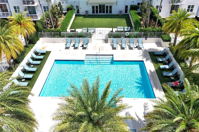 view of swimming pool featuring a patio and an outdoor bar