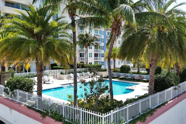 community pool featuring a patio area and fence